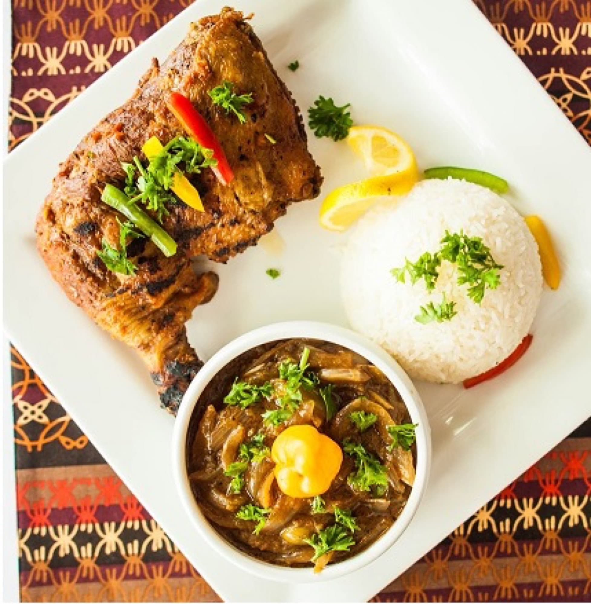 Chicken yassa — lemon and onion chicken with white rice