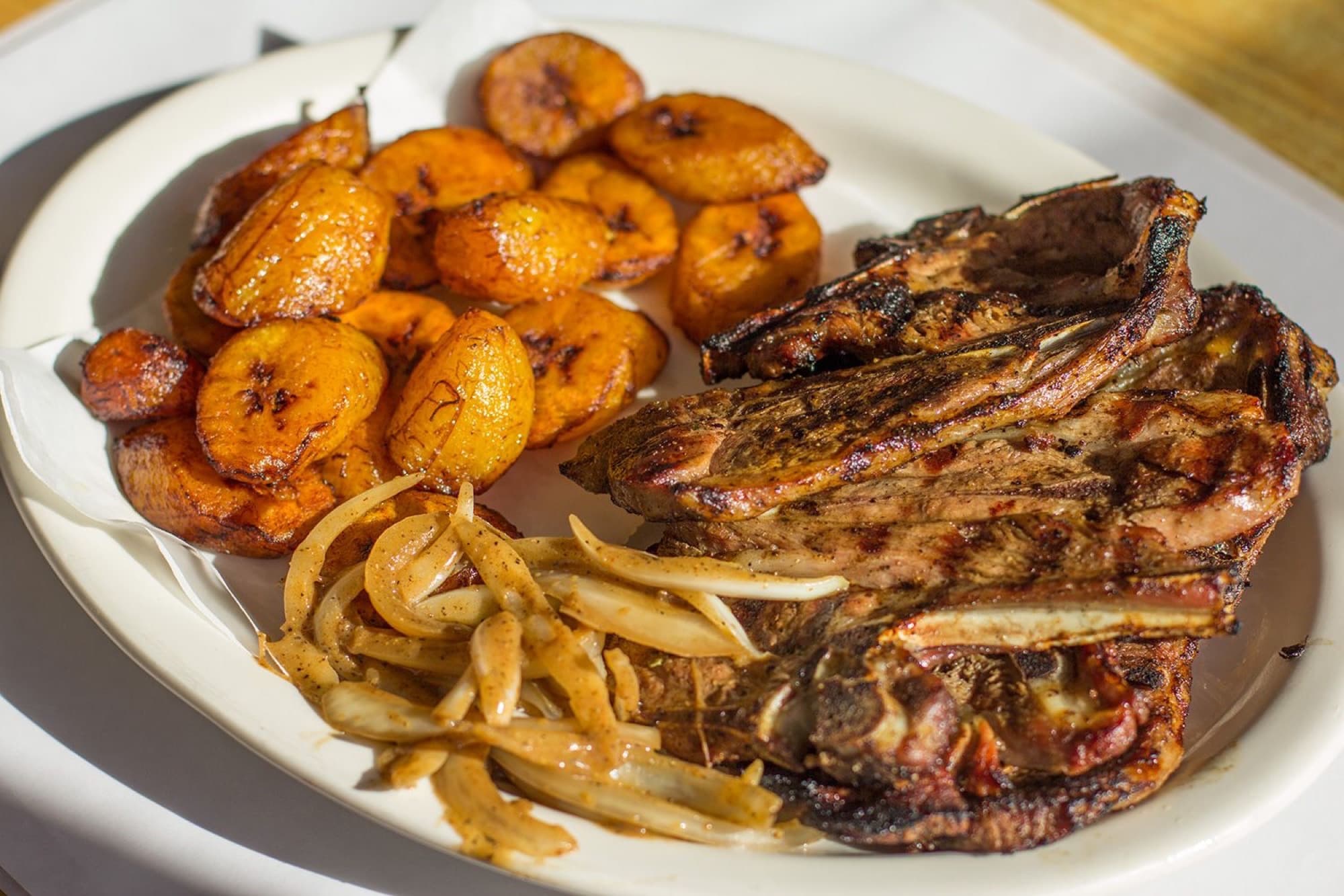 Dibi lamb — grilled lamb shoulder with fried plantains